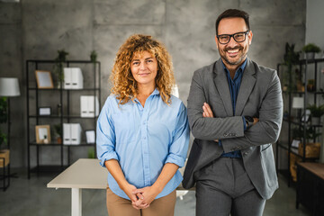 Wall Mural - Portrait of businessman and businesswoman at office