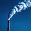 © lertsakwiman - Industrial smokestack emitting white smoke against a clear blue sky.