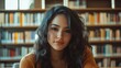 © kachanovski - Confident Latina girl studying in modern library setting