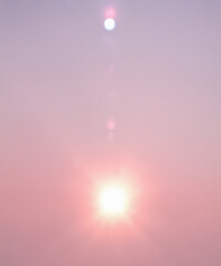 Wall Mural - sunbeam through the haze on pink sky, vertical