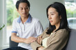 © Pormezz - Asian couple having relation problem. Wife crying and sitting separate with her husband at home after quarrel.