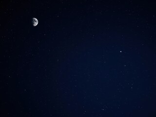 Wall Mural - Deep blue starry night sky filled with sparkling stars and a bright crescent moon, tranquil, space, cosmic