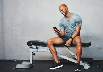 Poster - Fitness, gym and bench with African man on phone with exercise tracker and smile at wellness club. Happy, mockup and break with health insurance login to post training results for online reward