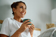 © Drazen - Happy woman having her morning coffee in bed.