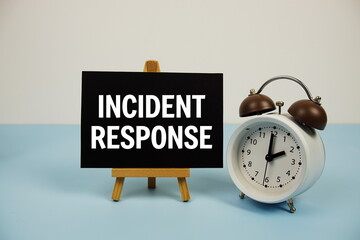 Wall Mural - incident response text on paper card with alarm clock on blue background