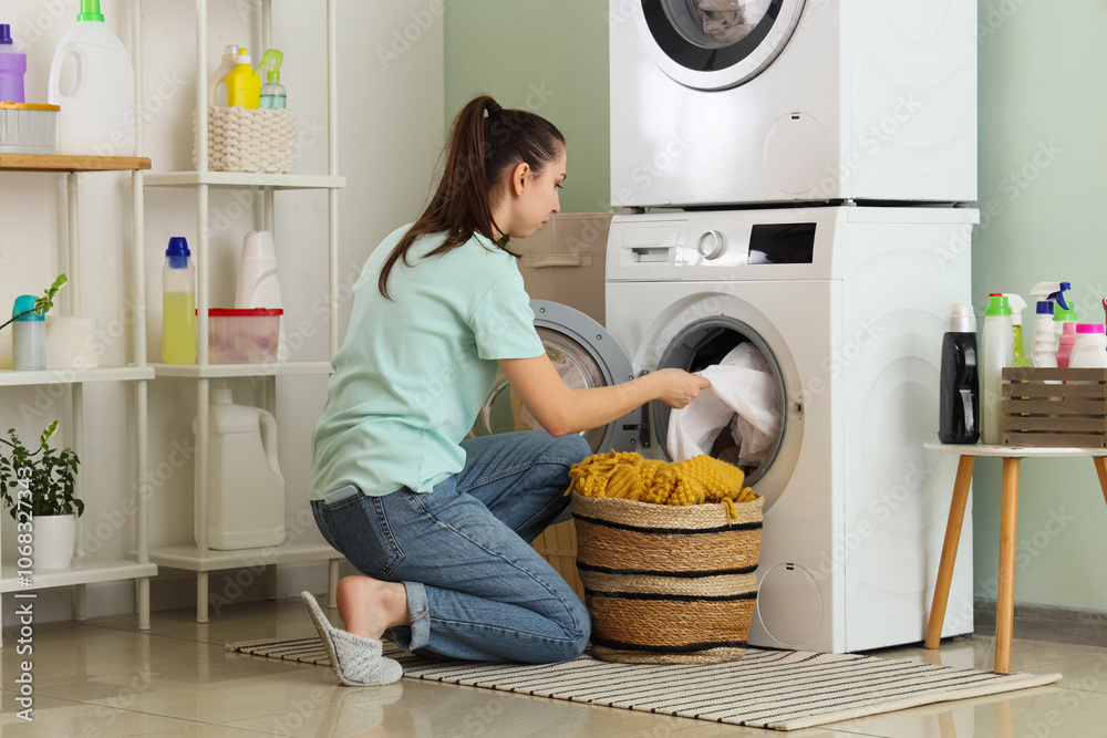 Young woman with basket doing laundry in room