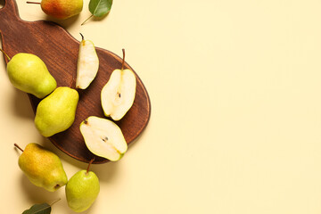 Wall Mural - Wooden board with sweet ripe pears on yellow background