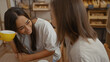 © Krakenimages.com - Women friends enjoying coffee together in a bakery, showing love and connection