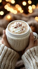 Fototapete - Hands holding a warm mug of hot chocolate topped with whipped cream and cinnamon in a cozy winter setting creating a seasonal drink atmosphere with side empty space for text Stockphoto style