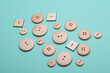 © splitov27 - Wooden buttons on mint green background close up