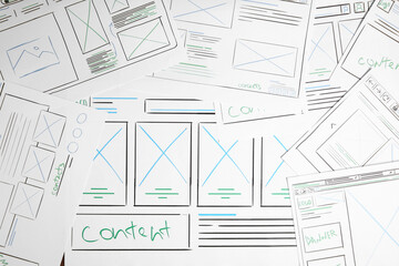 Leinwandbilder - Developing UI design. Sketches of website wireframes on as background, top view