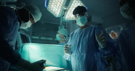 Poster - Portrait of a Female Surgeon Using an AR Headset, Analyzing Vital Patient Data Only Visible in Extended Reality Glasses, as Her Team Helps with the Medical Operation in a Hospital