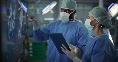 Poster - Diverse Colleagues Having a Discussion In the Operating Room. Female and Male Surgeons Evaluate Complex Brain Scans on a Large Display, Strategizing the Next Steps for the Operation