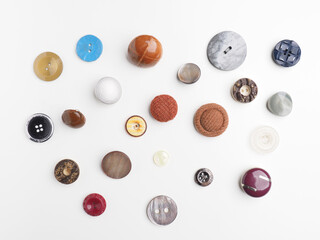 A collection of various vintage buttons on a white studio background