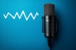 © Pedro - A condenser microphone with a shock mount is positioned on a blue background, with a white sound wave graphic to its left