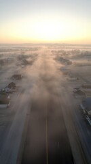 Wall Mural - In the early morning, a neighborhood is shrouded in thick fog with houses partially visible as the sun begins to rise, casting a warm glow