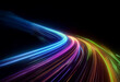 © joeycheung - A vibrant, colorful light trail curves across a black background, resembling a winding road or a fast-moving object.