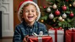© Leopard - A boy is holding a Christmas present and smiling