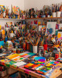 © bcendet - A colorful and messy artist's studio with paint brushes, paint tubes, and canvases.