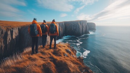 Wall Mural - Hikers admiring dramatic cliffs and ocean landscape in scotland