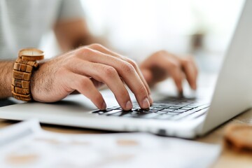 Poster - Hands type swiftly and efficiently on a laptop keyboard in a close-up shot, illustrating the focus and productivity of modern-day work settings and technology.