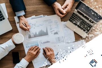 Poster - A diverse group of professionals works collaboratively on financial documents spread across a wooden table, using a laptop, smartphone, and charts, with hands discussing.