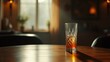 © realone952 - A glass half-filled with alcohol stands on the round table at home in the evening.