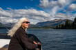 © Tetra Images - Woman with long white hair on boat on Lake Nahuel Huapi