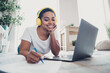 © deagreez - Photo of pretty young girl headphones write notepad laptop wear t-shirt modern interior apartment indoors