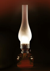 Burning old kerosene lamp on a dark background.