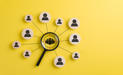 Wall Mural - target audience and customer focus concept. a black magnifying glass highlighting a group of people 