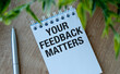 © Pawel - Top view image white paper card written text your feedback matters with a pen.