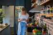 © Geber86 - Young woman cooking healthy vegetables in modern kitchen