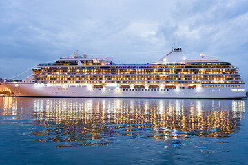 A cruise ship is seen at night docked at the port of Trieste, in the Friuli region of Italy. Concept of cruise tourism