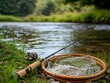 © Natanong - Tranquil Fishing Scene with Fly Rod and Net by River Bank