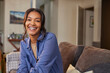 © Rido - Cheerful beautiful mixed race woman smiling at home