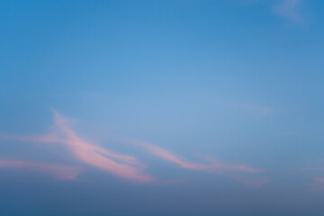 Wall Mural - blue sky with light pink clouds. abstract texture background evening twilight.