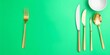 © PuriStudio - Various silver and gold flatware arranged neatly on a vibrant green background, design, modern