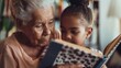 © Z A C - Warm moment of a grandmother reading with her grandson on her lap, both smiling.