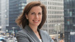 © Tom - A confident Caucasian woman in professional attire smiles for the camera, with a modern cityscape of skyscrapers in the background, exuding a sense of empowerment and professionalism.
