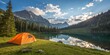 © Naiem - Lakeside Camping with Mountain Views and Orange Tent in Nature