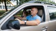 © Alexandru - Man driving with young girl passenger in car on suburban street