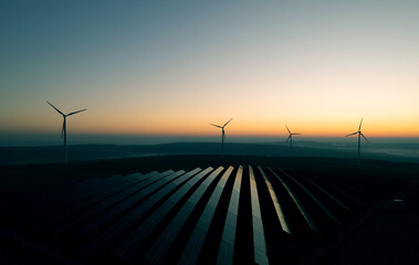 windmill turbines generating green energy electric.solar panels park and wind turbines at sunset.gre