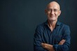 © Isuru - Confident mature man smiling with arms crossed  copy space.