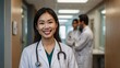 © Tatiana - Smiling Female Asian Doctor in a Hospital Setting with a Stethoscope