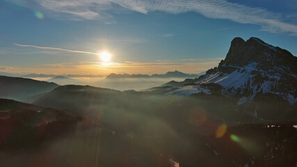 Wall Mural - rocky snow mountains and sunrise sun