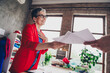 © deagreez - Portrait of dressmaker designer aged woman give concept paper client arm loft interior office studio indoors