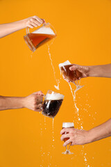 Hands with glasses pouring beer on orange background. Octoberfest celebration