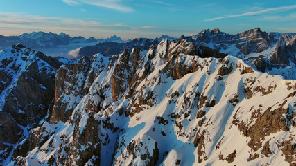 Wall Mural - rocky snow mountains at sunrise aerial