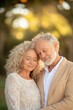 © Mandeep - Affectionate senior couple embracing outdoors with blurred nature background